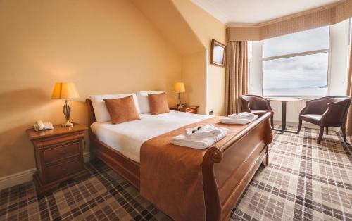 a hotel room with a bed and a window at SGE Esplanade Hotel in Dunoon