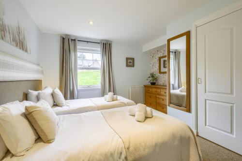 a bedroom with two beds and a window at Apartment 20 Inchmarlo in Banchory