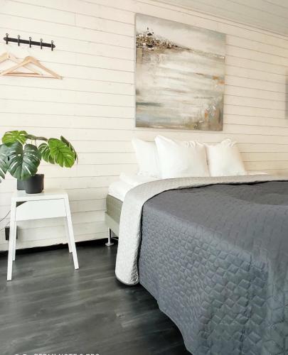a bedroom with a bed and a potted plant at Black Hotel in Kempele