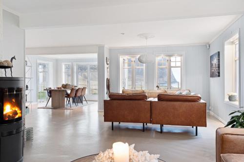 a living room with a couch and a fireplace at Unstad Arctic Resort in Unstad