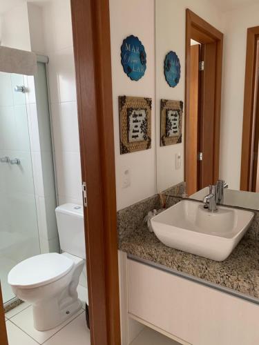uma casa de banho com um lavatório e um WC em Apartamento em Home Club em Penha
