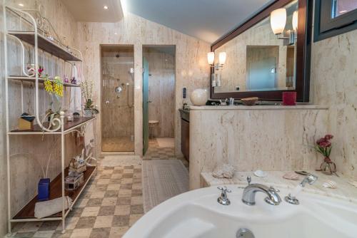 a bathroom with a tub and a sink and a shower at Villa Olivar - 5 BDR Dream Pool/Jacuzzi/Golf/BBQ in Torremolinos