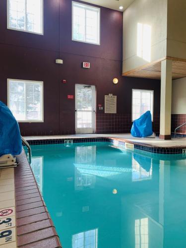 a swimming pool with blue water in a building at GrandStay Residential Suites Hotel in Saint Cloud