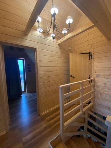 a room with a staircase in a wooden building at Little House in Ząb