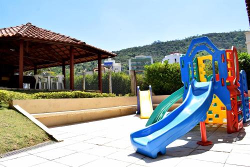 a playground with a slide in a park at Hotel CasaBlanca in Águas de Lindóia