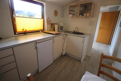 a small kitchen with a sink and a window at Haus Uschi - Ferienhaus in Cismar