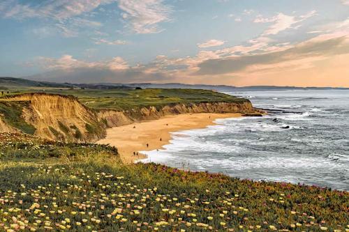 a view of a beach with people walking on it at Beach Villa Home - Walk to Beaches Trails Restaurants Activities & more in Half Moon Bay