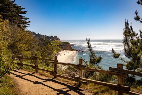 a wooden path leading to a beach with the ocean at Beach Villa Home - Walk to Beaches Trails Restaurants Activities & more in Half Moon Bay