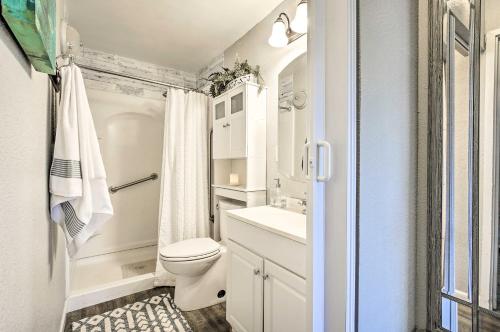 a small bathroom with a toilet and a sink at Lanai and Community Pool Access Sunny Central Condo in Kailua-Kona