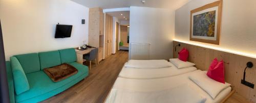 Un ou plusieurs lits dans un hébergement de l'établissement Alphotel Stocker Alpine Wellnesshotel