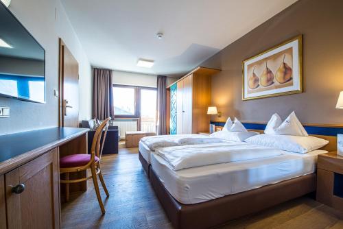 Un ou plusieurs lits dans un hébergement de l'établissement Alphotel Stocker Alpine Wellnesshotel