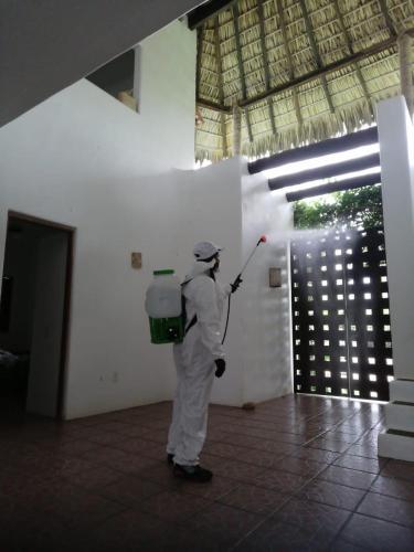 a man in white uniform standing in a room at Casa Maya private villa on the beach in Puerto Escondido