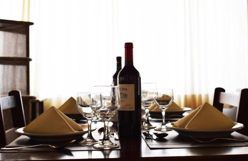 a bottle of wine sitting on a table with glasses at Hotel CasaBlanca in Águas de Lindóia