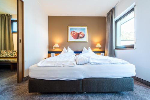 Un ou plusieurs lits dans un hébergement de l'établissement Alphotel Stocker Alpine Wellnesshotel