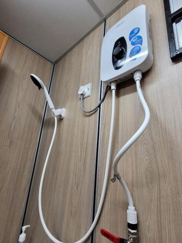 a video game controller hooked up to a wall at Hasina Resort @Sedili in Kota Tinggi