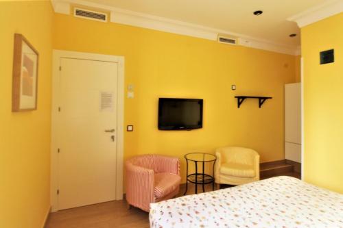 Postel nebo postele na pokoji v ubytování Hostal Arco Iris