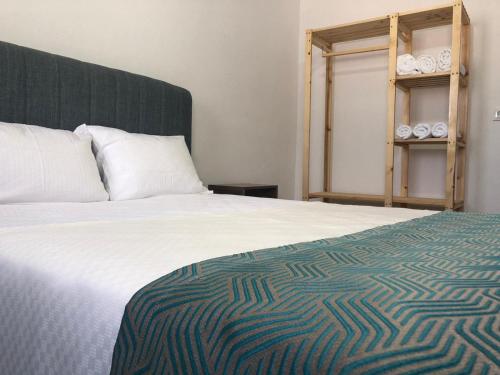 a bedroom with a bed and a shelf with towels at Demre Asya Apart in Demre