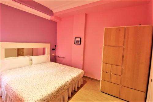 Postel nebo postele na pokoji v ubytování Hostal Arco Iris