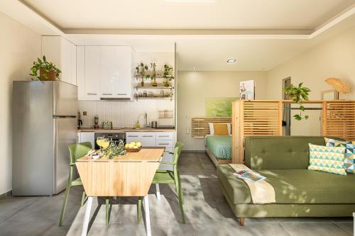 a kitchen and living room with a table and a couch at Olive Lemon Biophilic House & Lush Forest Garden in Vamos