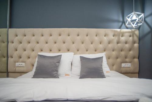 a bedroom with a large bed with a large headboard at Modern Mountain Apartman 202 in Kolašin