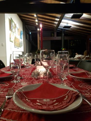 a table with wine glasses and a red table cloth at Pousada Tekoá Indiana in Cachoeiras de Macacu