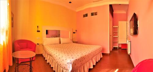 Postel nebo postele na pokoji v ubytování Hostal Arco Iris