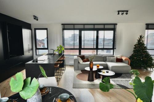 a living room with a christmas tree in it at The Penthouse, oasis of light and inspiration in Antwerp