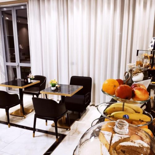 a room with two tables and a tray of fruit at Hotel Folen in Milan