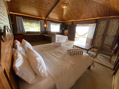 a bedroom with a large bed in a room at Collina Beach in Amontada