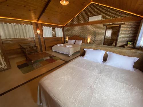 a bedroom with two beds in a room with at Collina Beach in Amontada