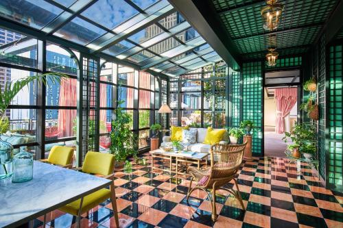 a conservatory with a living room with a glass ceiling at Virgin Hotels New Orleans in New Orleans