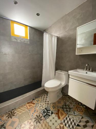 a bathroom with a toilet and a sink at Hotel Nest in San Juan