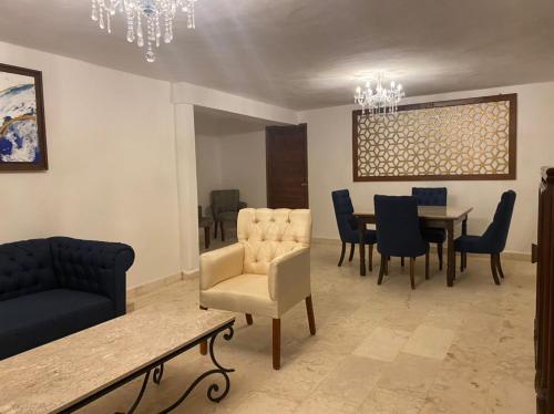 a living room with a dining room table and chairs at Real Hispano in Valladolid