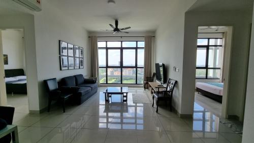 a living room with a couch and a bed at IOI Golf Suite in Putrajaya