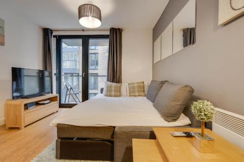 a living room with a bed and a tv at Arcadian City Centre Apartments with Balcony in Birmingham