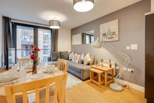 a living room with a table and a couch at Arcadian City Centre Apartments with Balcony in Birmingham