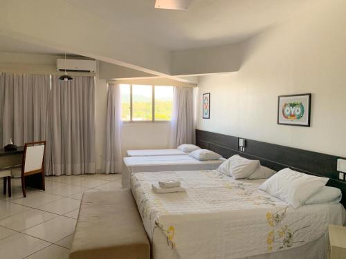 Postel nebo postele na pokoji v ubytování Hotel Comoditá Ltda