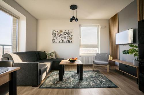a living room filled with furniture and a window at Bizapartments - Modern Flats in Warsaw