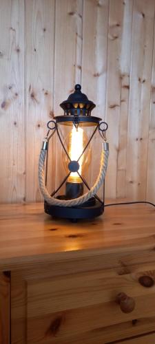 a lantern sitting on top of a wooden table at Känzeli - Ferienwohnung mit Traumaussicht in Beatenberg