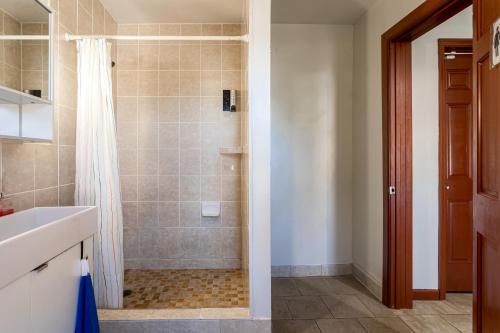 a bathroom with a shower and a sink at 1 Bus Stop To NYC-Hot Tub-EWR Airport-Free Parking in Hillside