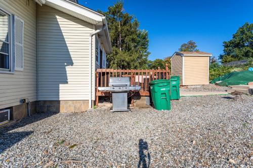a backyard with a grill and two green trash cans at 1 Bus Stop To NYC-Hot Tub-EWR Airport-Free Parking in Hillside