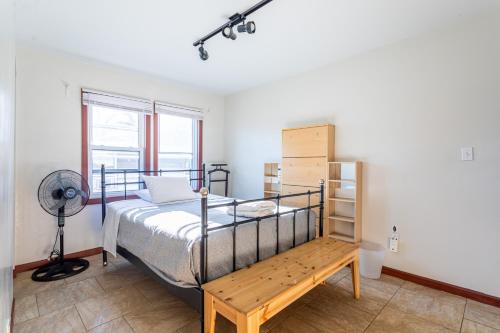 a bedroom with a bed and a fan at 1 Bus Stop To NYC-Hot Tub-EWR Airport-Free Parking in Hillside