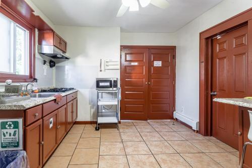 a kitchen with a sink and a stove top oven at 1 Bus Stop To NYC-Hot Tub-EWR Airport-Free Parking in Hillside