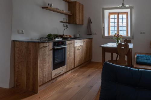 een keuken met houten kasten en een fornuis met oven bij Bauernhof Hof Unternberg in Magrè allʼ Adige