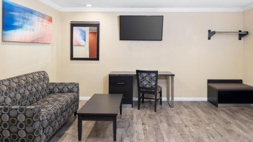 a waiting room with a couch and a table at Scandia Motel in Carlsbad
