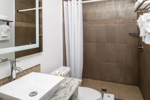 a bathroom with a sink and a shower at Scandia Motel in Carlsbad