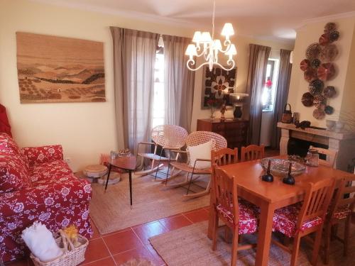 a living room with a couch and a table at Casa do Adro-Passadiços do Paiva Arouca in Arouca