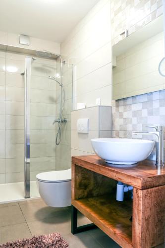 a bathroom with a sink and a toilet and a shower at Villa Kajgo-Pag in Pag