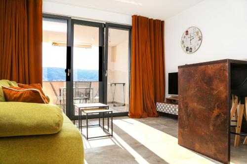 a living room with a couch and a clock on the wall at Villa Kajgo-Pag in Pag
