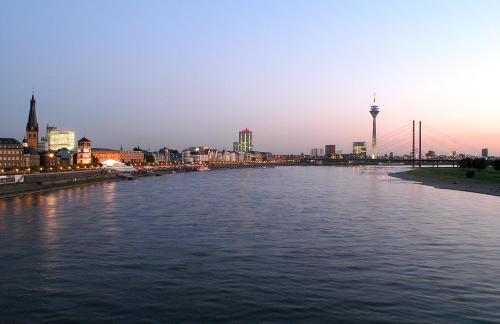 a view of a river with a city in the background at Hotel Ko in Düsseldorf